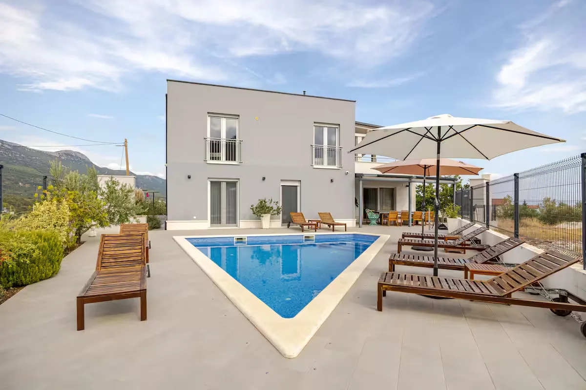 Villa Mila pool at golden hour with mountain backdrop